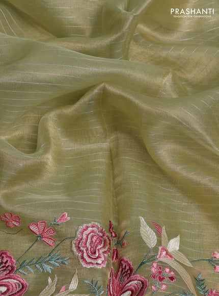 Tissue silk saree elachi green with allover zari weaves and kutch embroidery border