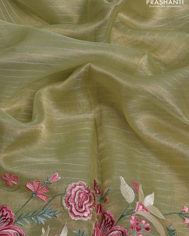 Tissue silk saree elachi green with allover zari weaves and kutch embroidery border