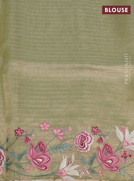 Tissue silk saree elachi green with allover zari weaves and kutch embroidery border