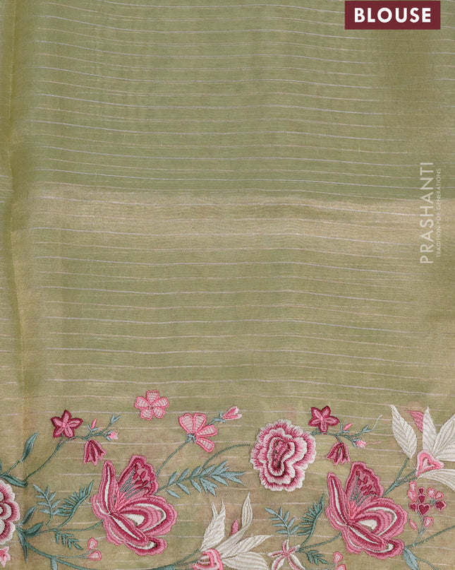Tissue silk saree elachi green with allover zari weaves and kutch embroidery border
