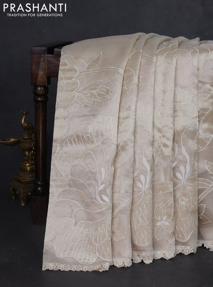 Tissue silk saree off white with allover floral applique work and embroidery border