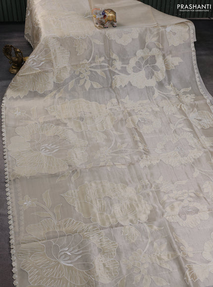 Tissue silk saree off white with allover floral applique work and embroidery border