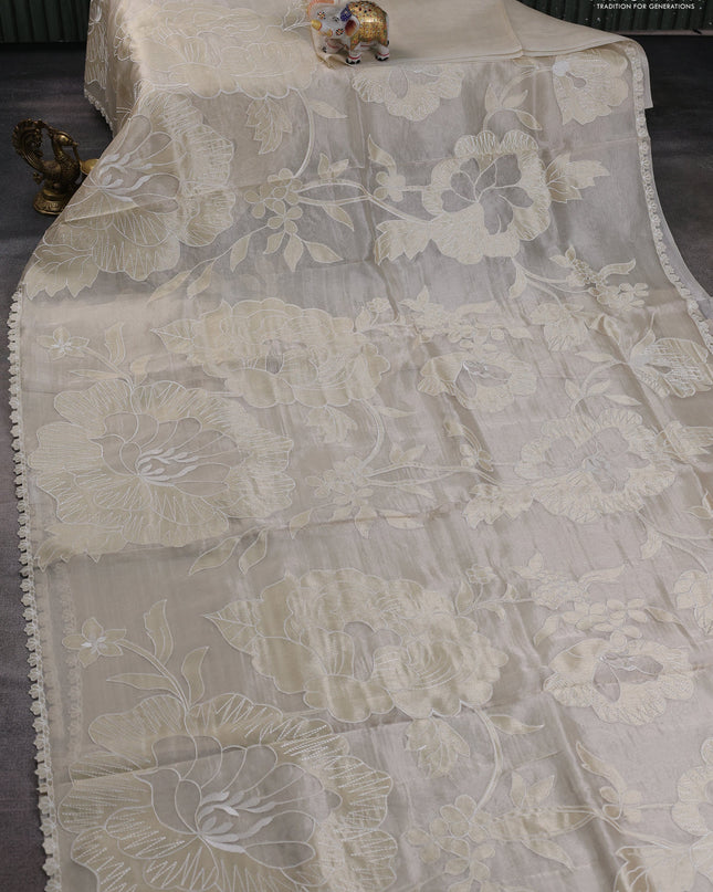 Tissue silk saree off white with allover floral applique work and embroidery border