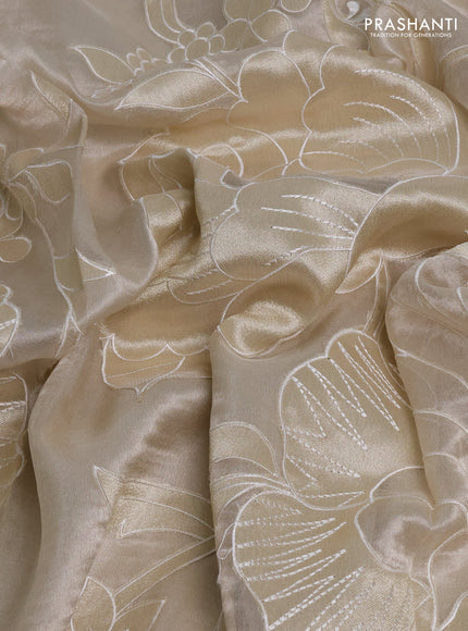 Tissue silk saree off white with allover floral applique work and embroidery border