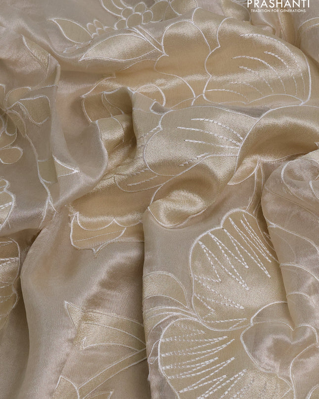 Tissue silk saree off white with allover floral applique work and embroidery border