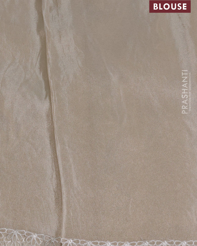 Tissue silk saree off white with allover floral applique work and embroidery border