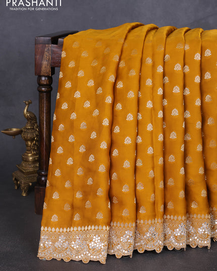 Banarasi silk saree dark mustard with allover zari woven buttas and mirror work embroidery border
