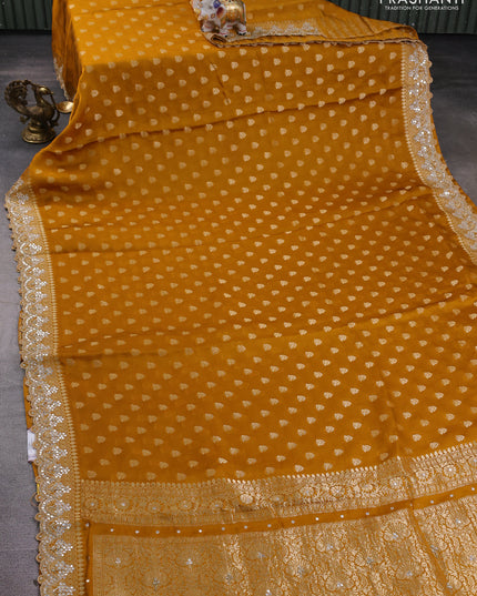 Banarasi silk saree dark mustard with allover zari woven buttas and mirror work embroidery border