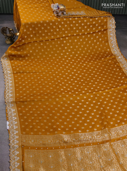 Banarasi silk saree dark mustard with allover zari woven buttas and mirror work embroidery border