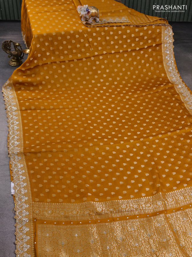 Banarasi silk saree dark mustard with allover zari woven buttas and mirror work embroidery border