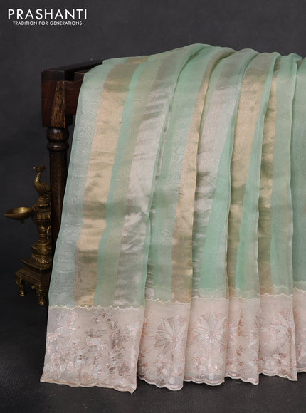 Pure organza silk saree pastel green and cream with allover silver & gold stripes pattern and embroidery border