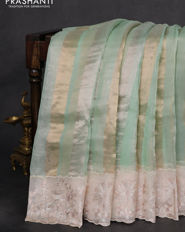 Pure organza silk saree pastel green and cream with allover silver & gold stripes pattern and embroidery border