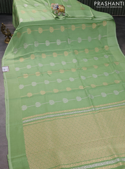 Banarasi mushru silk saree pastel green with allover stripes pattern & zari buttas and satin border