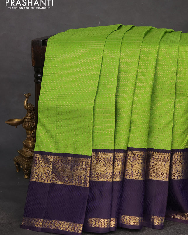 Pure kanchipuram silk saree light green and deep jamun with allover zari woven lakshadeepam pattern and rich zari woven simple border