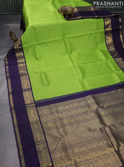 Pure kanchipuram silk saree light green and deep jamun with allover zari woven lakshadeepam pattern and rich zari woven simple border
