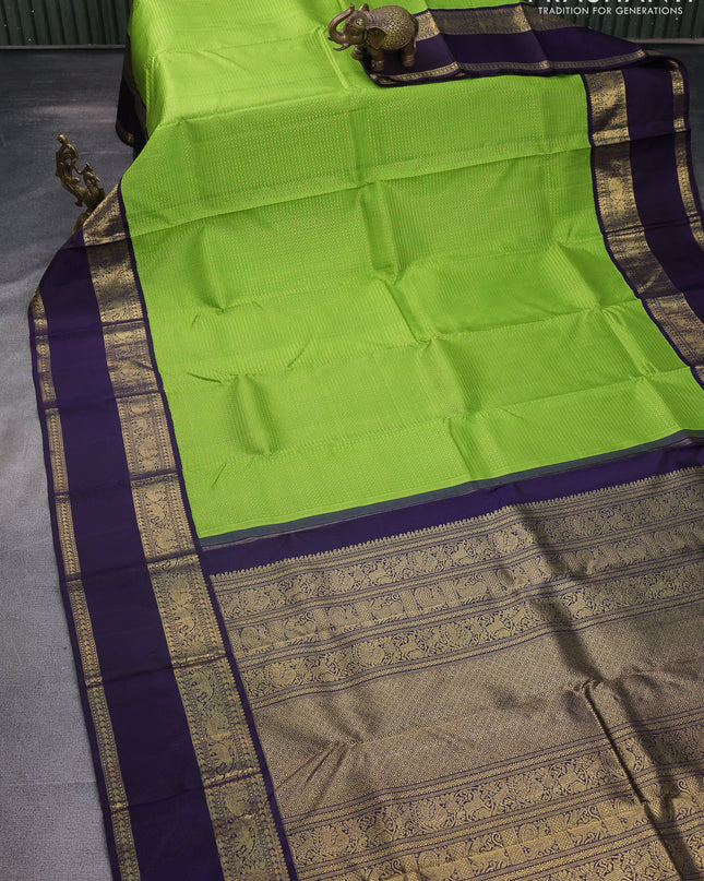 Pure kanchipuram silk saree light green and deep jamun with allover zari woven lakshadeepam pattern and rich zari woven simple border