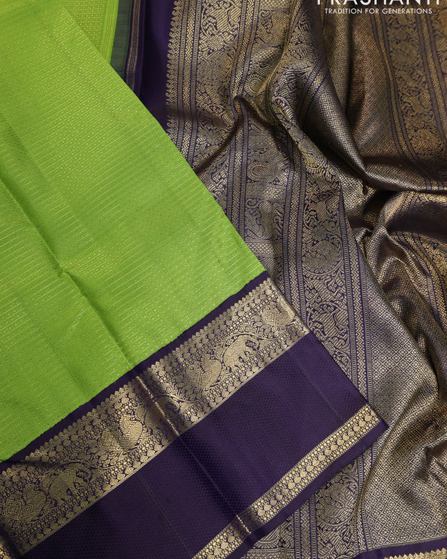 Pure kanchipuram silk saree light green and deep jamun with allover zari woven lakshadeepam pattern and rich zari woven simple border