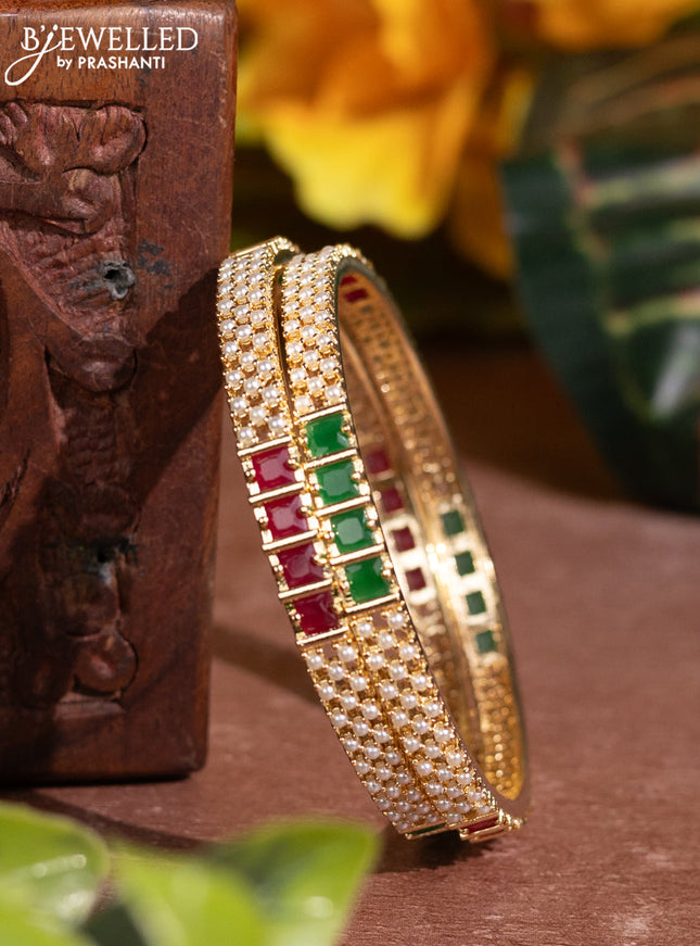 Pearl bangles with kemp stones and pearls in gold finish