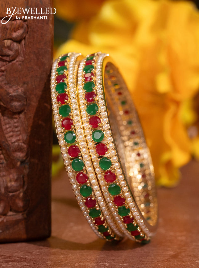 Pearl bangles with kemp stones and pearls in gold finish