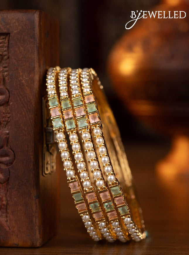 Pearl bangles  design with mint green & baby pink stones and pearls in gold finish