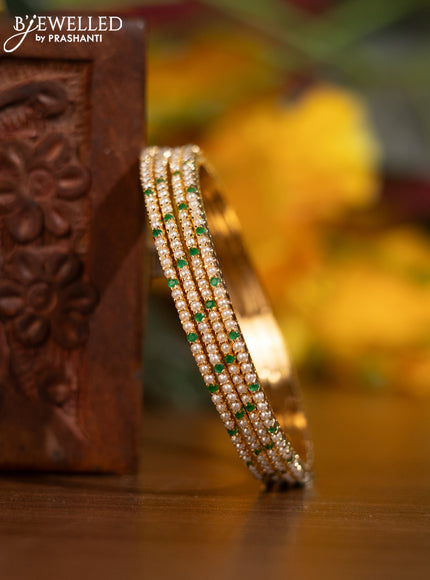 Pearl bangle with emerald stones and pearls in gold finish