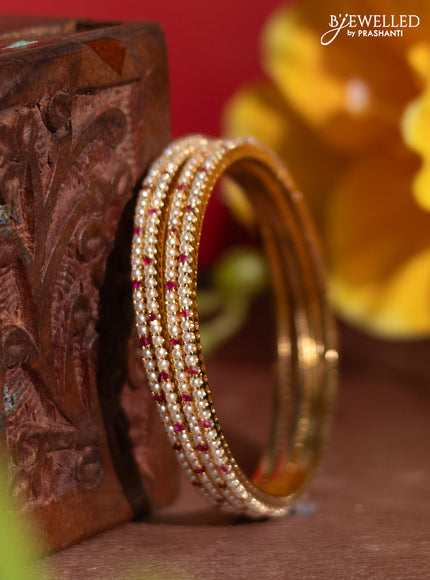 Pearl bangles with ruby stones and pearls in gold finish