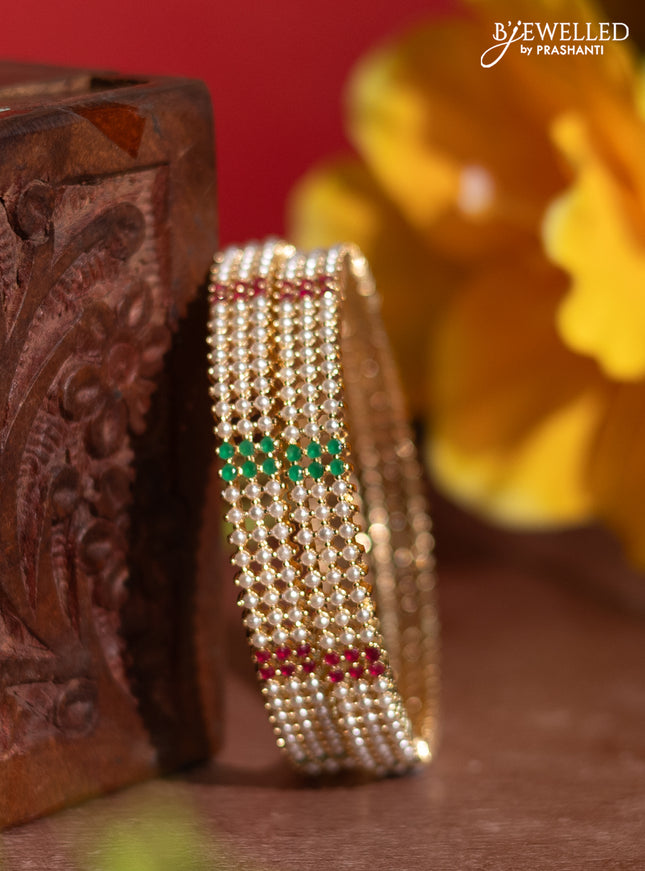 Pearl bangles with kemp stones and pearls in gold finish
