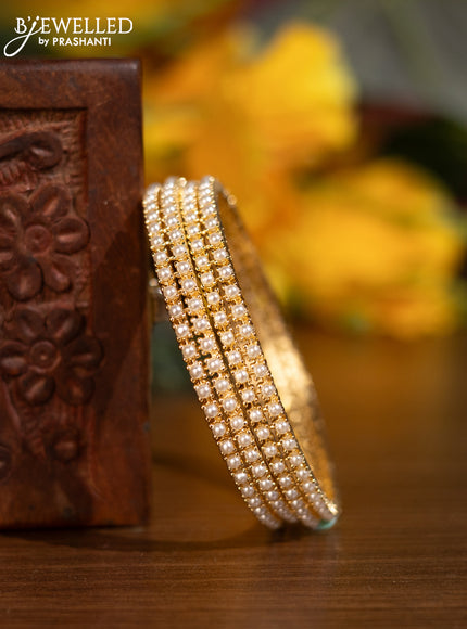 Pearl bangles with pearls in gold finish