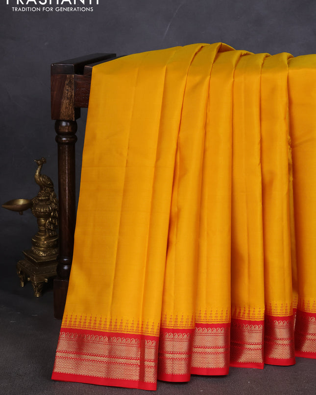 Pure kanchipuram silk saree mustard yellow and red with plain body and zari woven korvai border