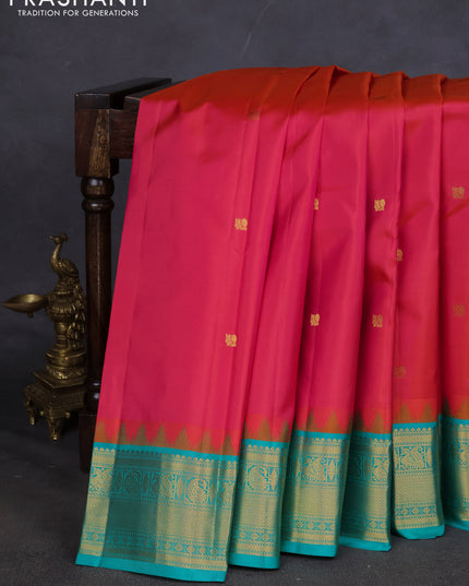 Pure kanchipuram silk saree dual shade of pinkish orange and teal blue with annam zari woven buttas and zari woven korvai border