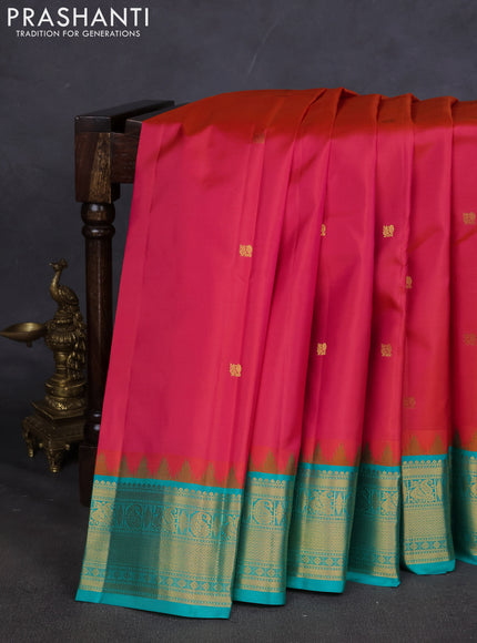 Pure kanchipuram silk saree dual shade of pinkish orange and teal blue with annam zari woven buttas and zari woven korvai border