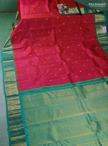 Pure kanchipuram silk saree dual shade of pinkish orange and teal blue with annam zari woven buttas and zari woven korvai border