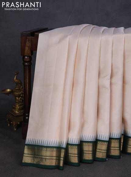 Pure kanchipuram silk saree off white and dark green with plain body and temple design zari woven border