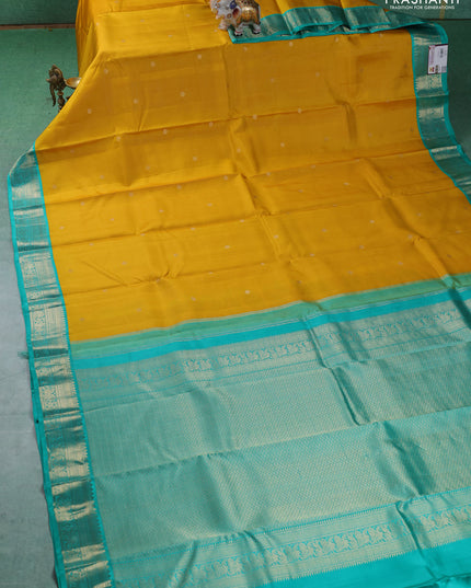 Pure kanchipuram silk saree mustard yellow and teal blue with allover zari weaves & buttas and zari woven korvai border