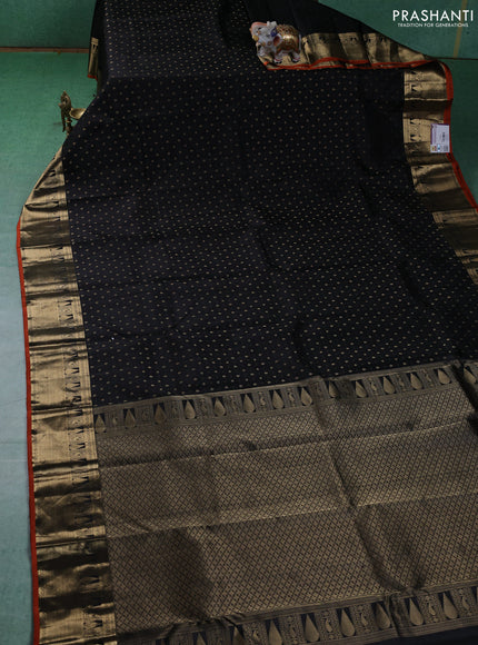 Pure kanchipuram silk saree black and orange with allover zari butta weaves and zari woven border