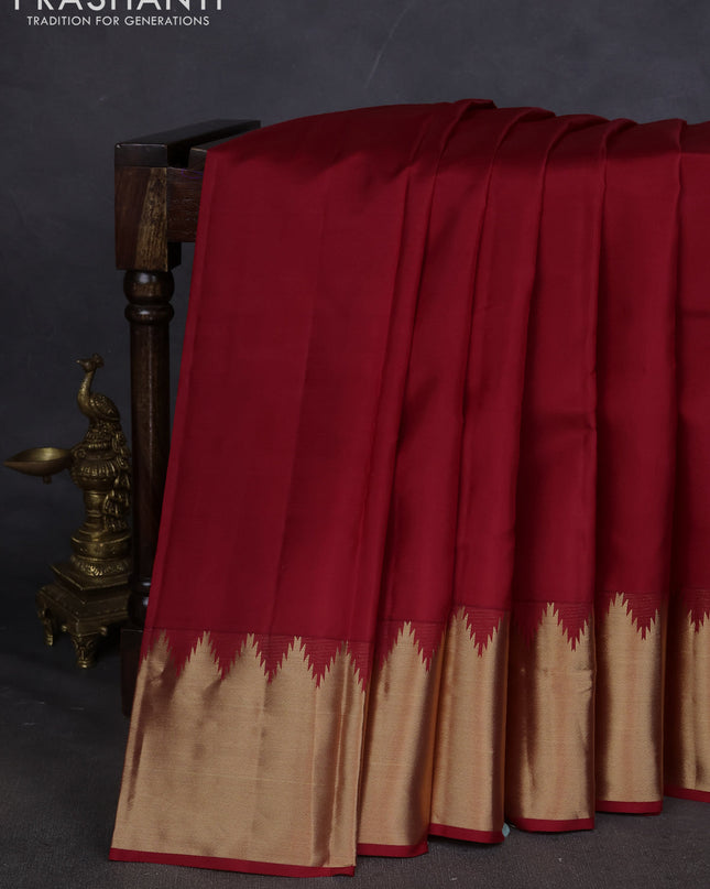 Pure kanchipuram silk saree maroon with plain body and temple design zari woven border