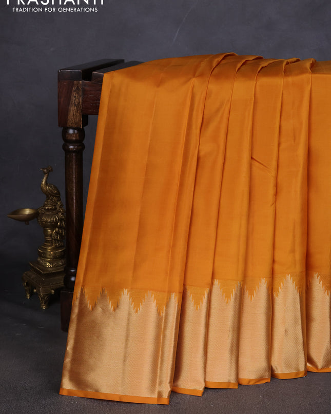 Pure kanchipuram silk saree mustard yellow with plain body and temple design zari woven border
