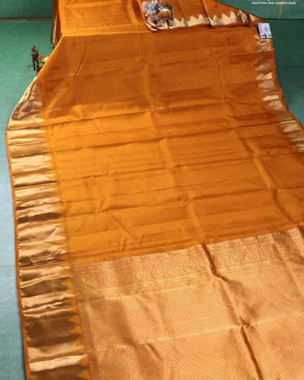 Pure kanchipuram silk saree mustard yellow with plain body and temple design zari woven border