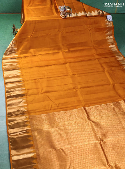 Pure kanchipuram silk saree mustard yellow with plain body and temple design zari woven border