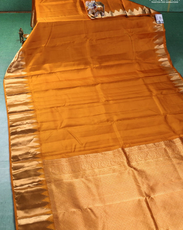 Pure kanchipuram silk saree mustard yellow with plain body and temple design zari woven border