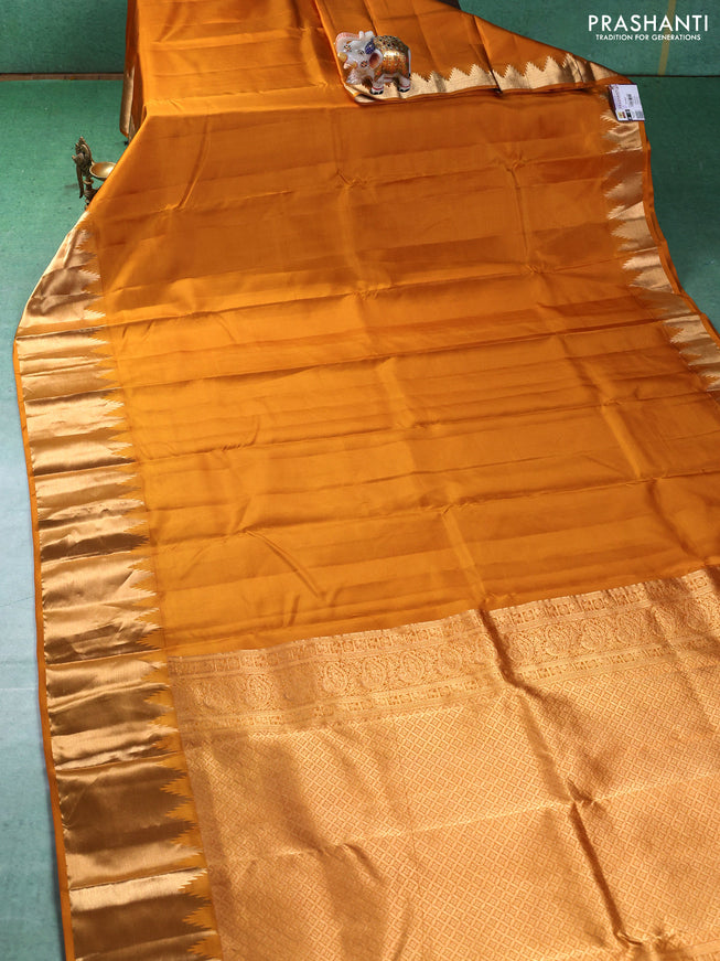 Pure kanchipuram silk saree mustard yellow with plain body and temple design zari woven border