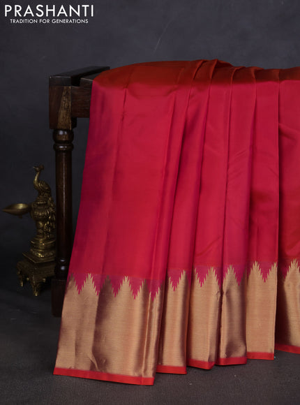 Pure kanchipuram silk saree dual shade of pinkish orange with plain body and temple design zari woven border