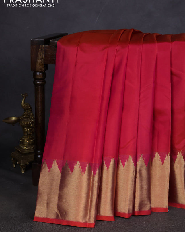 Pure kanchipuram silk saree dual shade of pinkish orange with plain body and temple design zari woven border