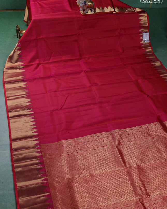 Pure kanchipuram silk saree dual shade of pinkish orange with plain body and temple design zari woven border