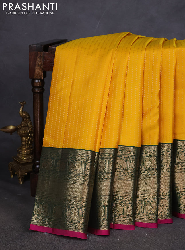 Pure kanchipuram silk saree yellow and dark green with allover zari woven butta weaves and long zari woven korvai border