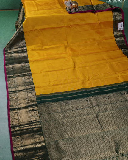 Pure kanchipuram silk saree yellow and dark green with allover zari woven butta weaves and long zari woven korvai border