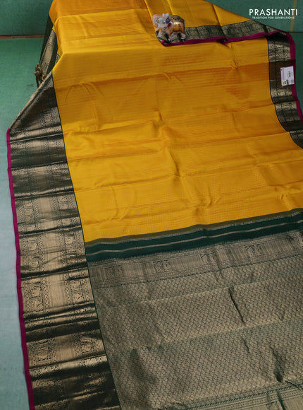 Pure kanchipuram silk saree yellow and dark green with allover zari woven butta weaves and long zari woven korvai border
