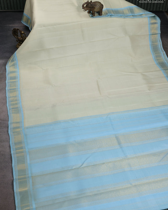 Pure kanchipuram silk saree off white and pastel blue with allover stripes pattern and zari woven korvai border