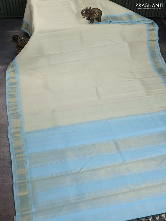 Pure kanchipuram silk saree off white and pastel blue with allover stripes pattern and zari woven korvai border