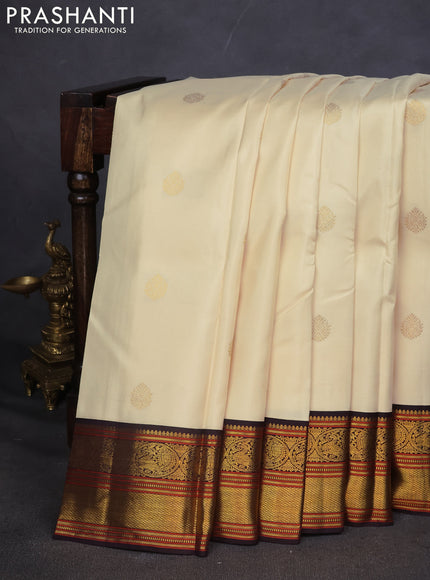 Pure kanchipuram silk saree off white and coffee brown with zari woven buttas and zari woven korvai border